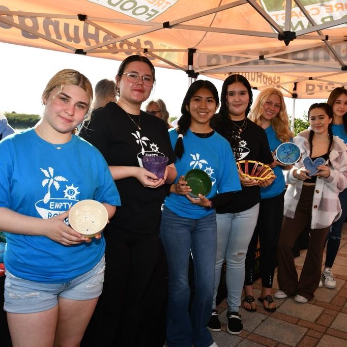 Students displaying ceramic bowls for Empty Bowls event in downtown Fort Pierce.